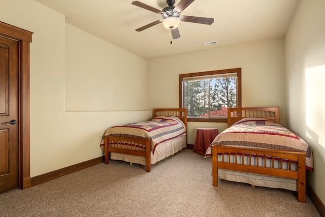 bedroom with baseboards, ceiling fan, light colored carpet, and visible vents
