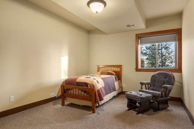 bedroom with baseboards, visible vents, and carpet