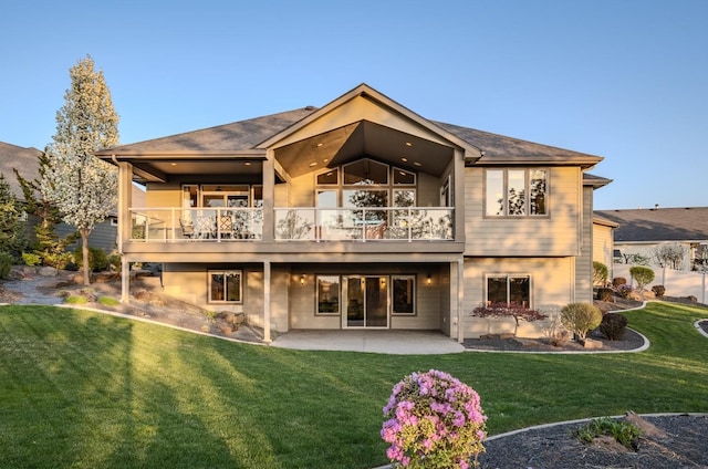 rear view of house with a yard and a patio area