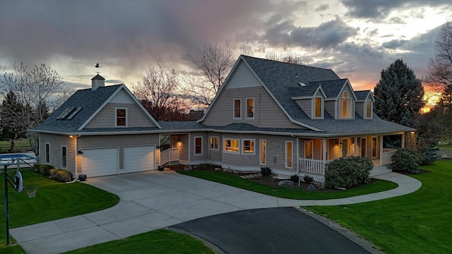 view of front facade featuring a porch, driveway, a front yard, an attached garage, and a shingled roof