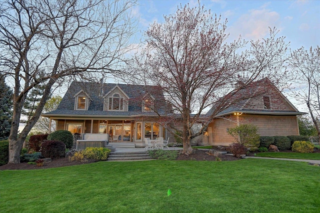 view of front of house featuring a front lawn and covered porch