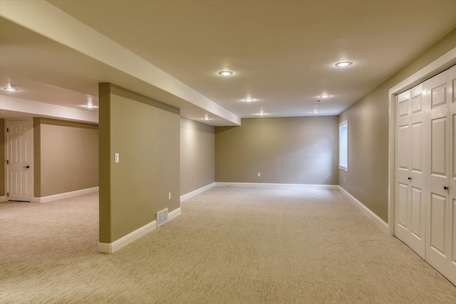 basement with recessed lighting, baseboards, light colored carpet, and visible vents