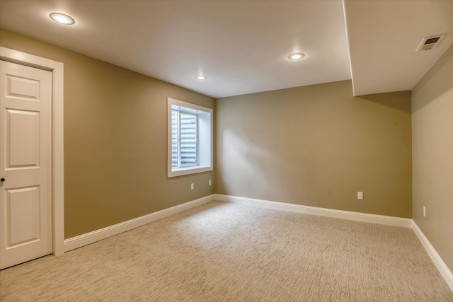 empty room featuring recessed lighting, baseboards, visible vents, and light carpet