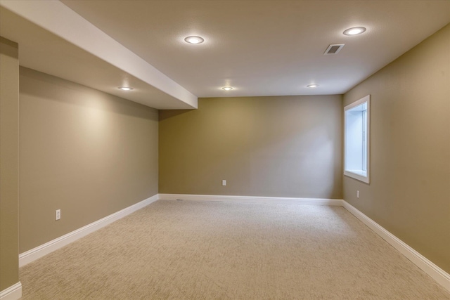 empty room featuring light carpet, recessed lighting, and visible vents