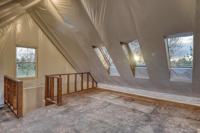 bonus room featuring vaulted ceiling with skylight