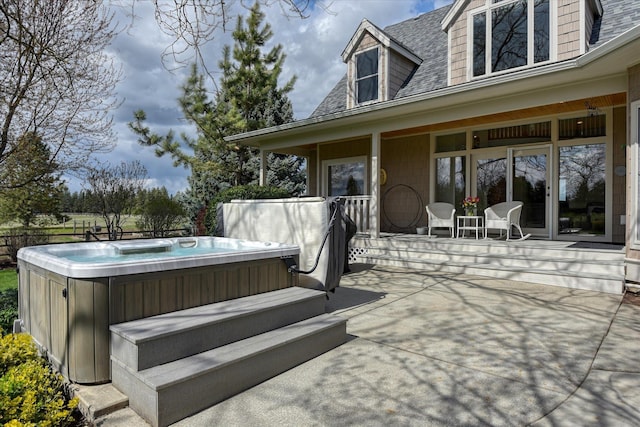 wooden deck with a patio and a hot tub