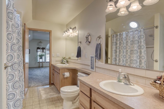 full bath with vanity, a shower with shower curtain, toilet, and an inviting chandelier