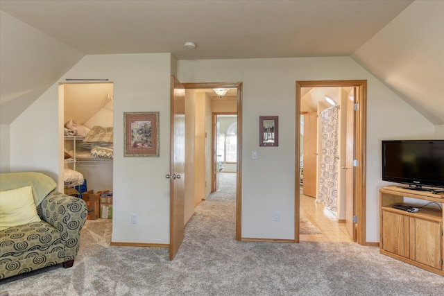 living area featuring carpet floors and vaulted ceiling