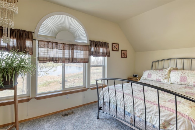 bedroom with visible vents, baseboards, carpet floors, and lofted ceiling