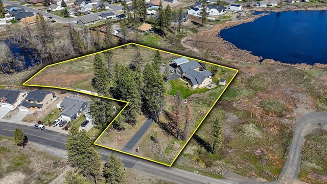 bird's eye view with a water view and a residential view