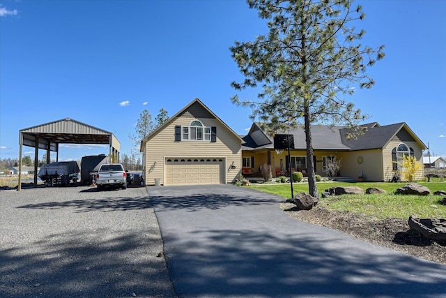 view of front of house with an attached garage, a front lawn, and aphalt driveway