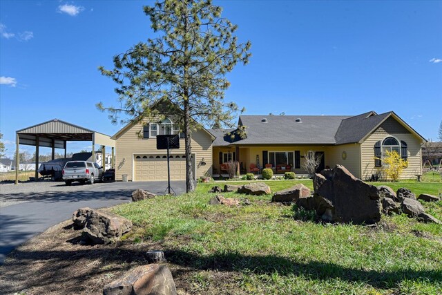 view of front of house featuring an attached garage and aphalt driveway
