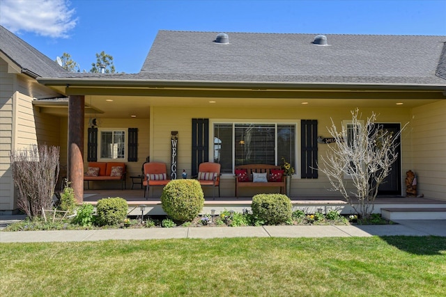 back of property with a yard and covered porch