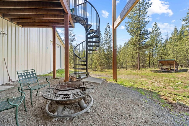 view of patio with stairs and an outdoor fire pit