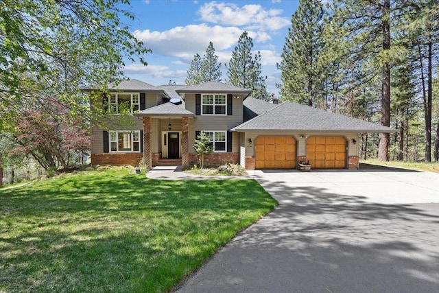 view of front of property featuring brick siding, driveway, a front yard, and a garage
