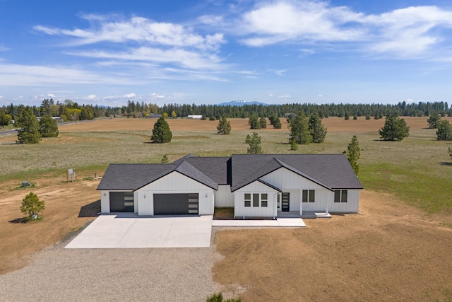 3621 W Montgomery Rd, Deer Park, WA 99006 - view of front facade featuring a garage, a shingled roof, board and batten siding, a rural view, and driveway