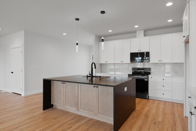 3621 W Montgomery Rd, Deer Park, WA 99006 - kitchen featuring a sink, black electric range oven, stainless steel microwave, and light wood finished floors