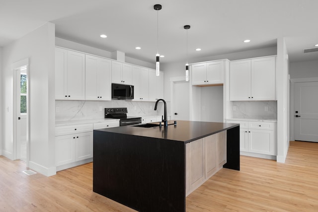 3621 W Montgomery Rd, Deer Park, WA 99006 - kitchen with black microwave, a sink, electric range oven, light wood-style flooring, and recessed lighting