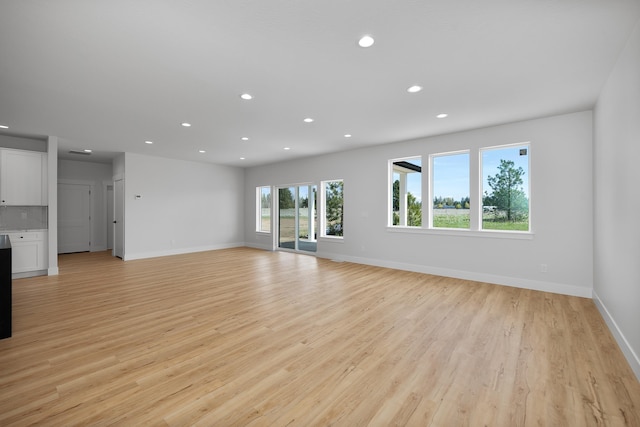 3621 W Montgomery Rd, Deer Park, WA 99006 - unfurnished living room with baseboards, light wood finished floors, and recessed lighting