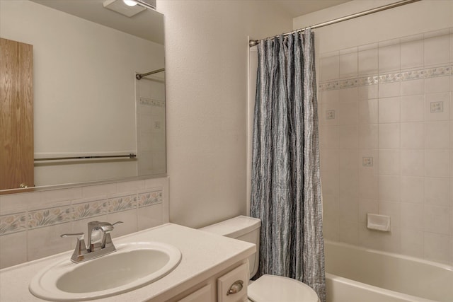 bathroom featuring vanity, backsplash, shower / bath combo, and toilet