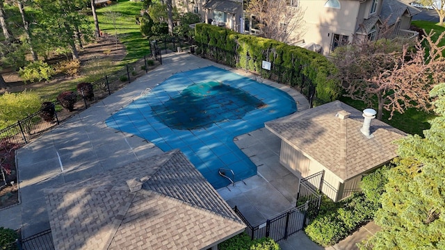 pool with a patio and fence