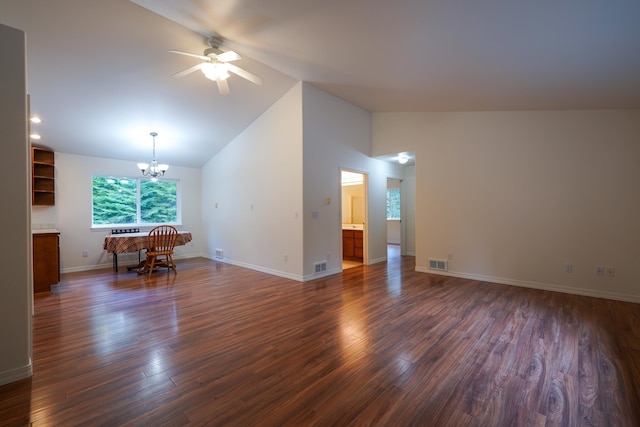 unfurnished living room with dark wood-type flooring, baseboards, ceiling fan with notable chandelier, and visible vents