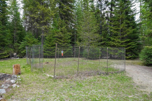 view of yard with a view of trees