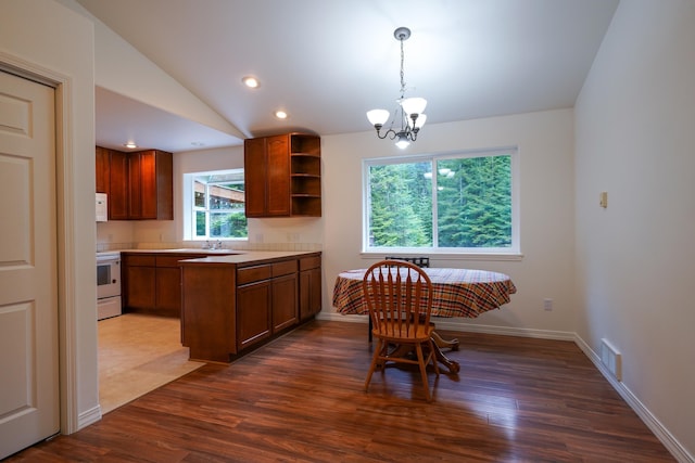 dining room featuring dark wood-style flooring, visible vents, vaulted ceiling, baseboards, and a chandelier