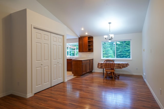 dining area with dark wood-type flooring, baseboards, lofted ceiling, and a notable chandelier