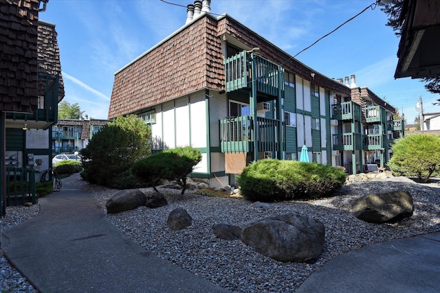 2121 E Upriver Dr # 19, Spokane, WA 99207 - exterior space with a chimney, mansard roof, and a balcony