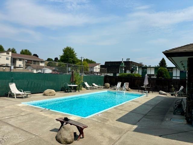 2121 E Upriver Dr # 19, Spokane, WA 99207 - community pool featuring a fenced backyard and a patio area