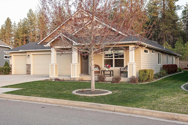 craftsman house with a porch, a front lawn, an attached garage, and concrete driveway