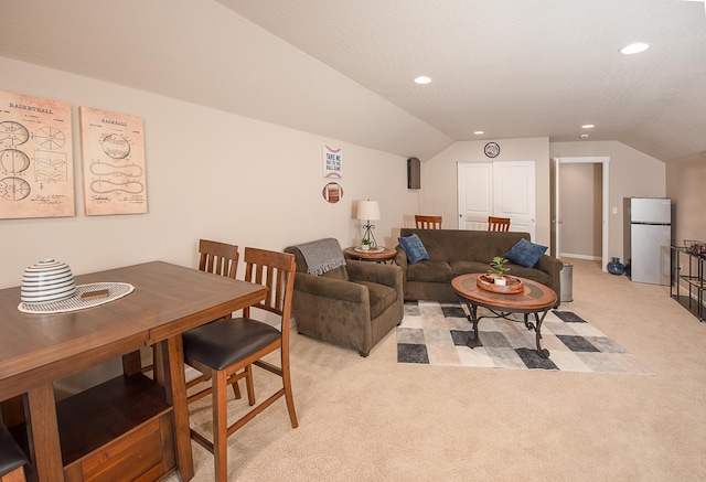 living room featuring vaulted ceiling, recessed lighting, and light colored carpet