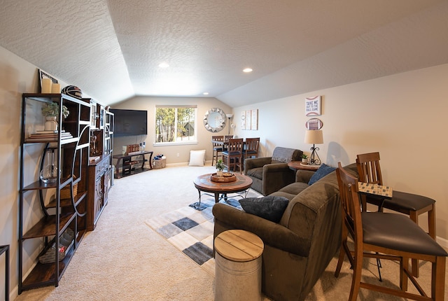 living area featuring baseboards, light carpet, vaulted ceiling, and a textured ceiling