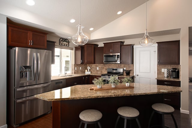 kitchen with dark wood-style flooring, appliances with stainless steel finishes, decorative backsplash, and a sink
