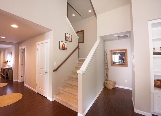 stairs with recessed lighting, baseboards, and wood finished floors
