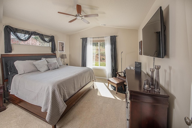 bedroom with carpet floors, a ceiling fan, vaulted ceiling, and visible vents