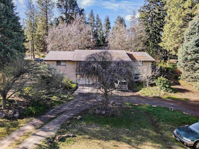 obstructed view of property featuring aphalt driveway