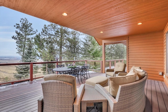 wooden terrace with outdoor dining area