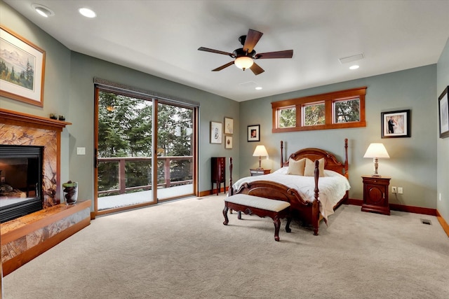 bedroom featuring access to exterior, carpet, and a fireplace