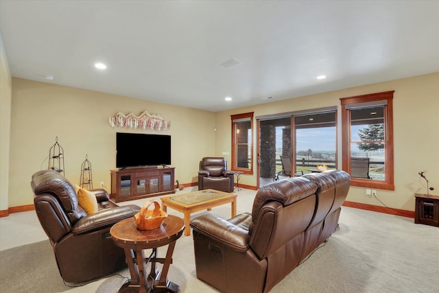 living room featuring light colored carpet, recessed lighting, and baseboards