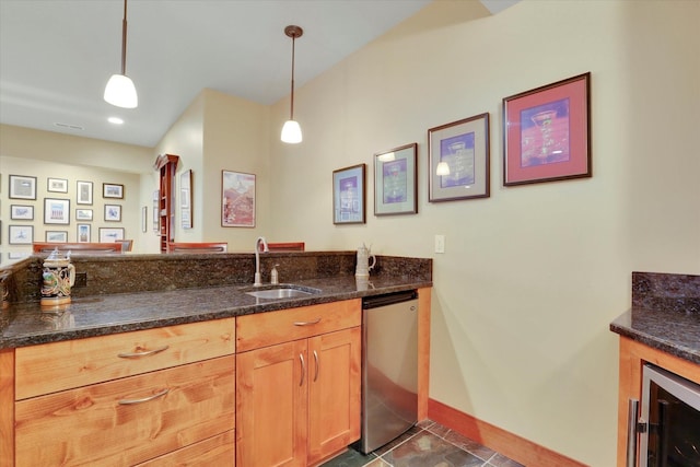 kitchen featuring beverage cooler, refrigerator, a sink, and dark stone countertops