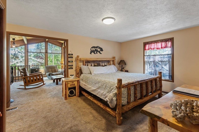 carpeted bedroom with access to outside, a textured ceiling, visible vents, and multiple windows