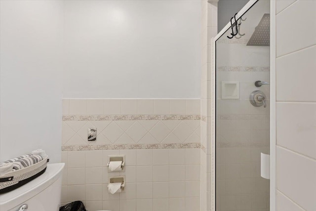 full bathroom with toilet and a stall shower