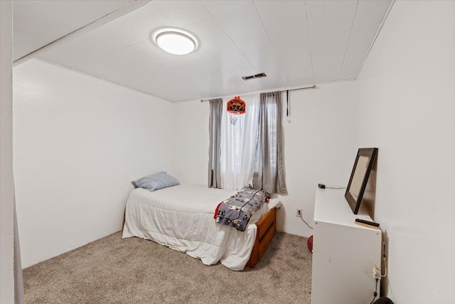bedroom with visible vents and carpet
