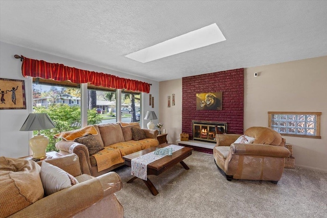 living area with carpet, a textured ceiling, a brick fireplace, and a skylight