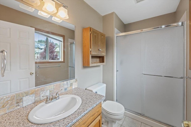 full bathroom with vanity, decorative backsplash, tile patterned flooring, toilet, and a stall shower