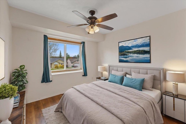 bedroom with baseboards, a ceiling fan, and wood finished floors