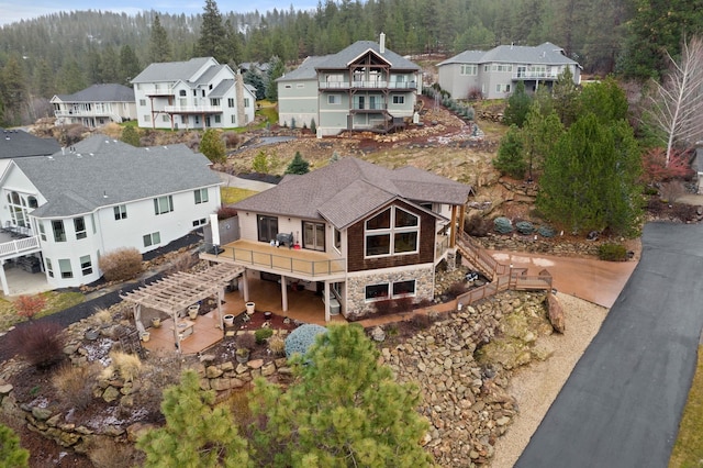 birds eye view of property featuring a residential view and a wooded view