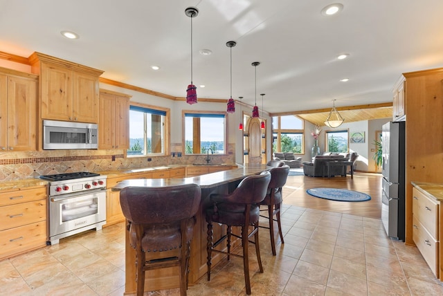 kitchen with decorative backsplash, light brown cabinetry, a kitchen breakfast bar, recessed lighting, and appliances with stainless steel finishes